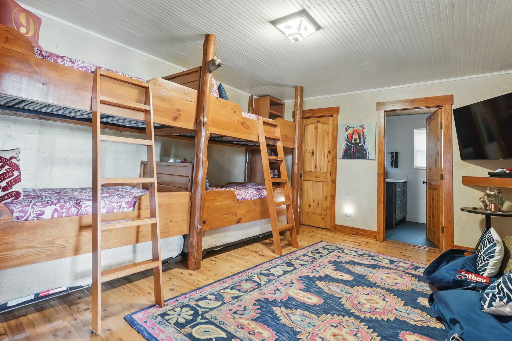 Bunk room with log beds in a short term rental lake cabin in Hot Springs, Arkansas