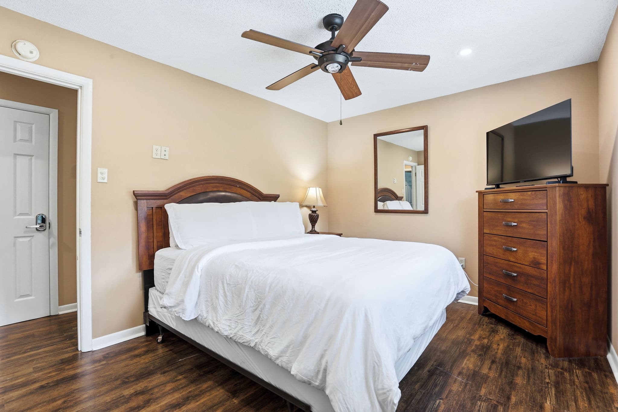 Guest bedroom made up with white hotel bedding in a short term rental in North Little Rock, Arkansas