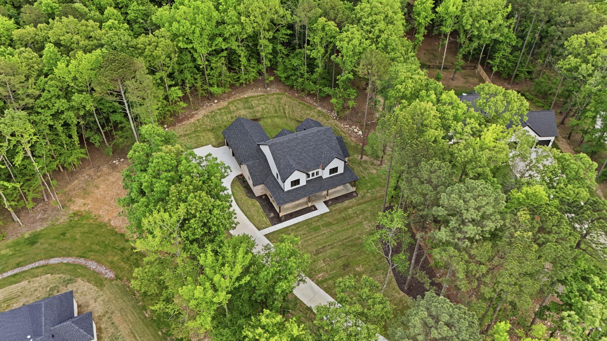 Aerial photo of a new construction home on a wooded lot in Bryant, Arkansas
