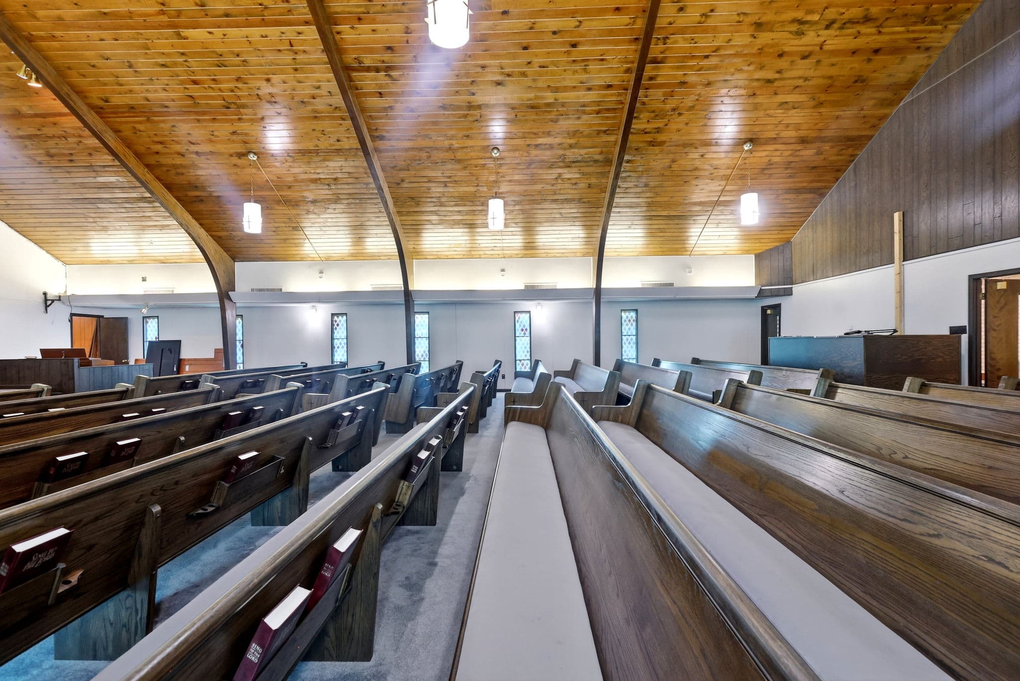 Church sanctuary with warm wood and pews at 2400 West 31st Avenue in Pine Bluff, Arkansas