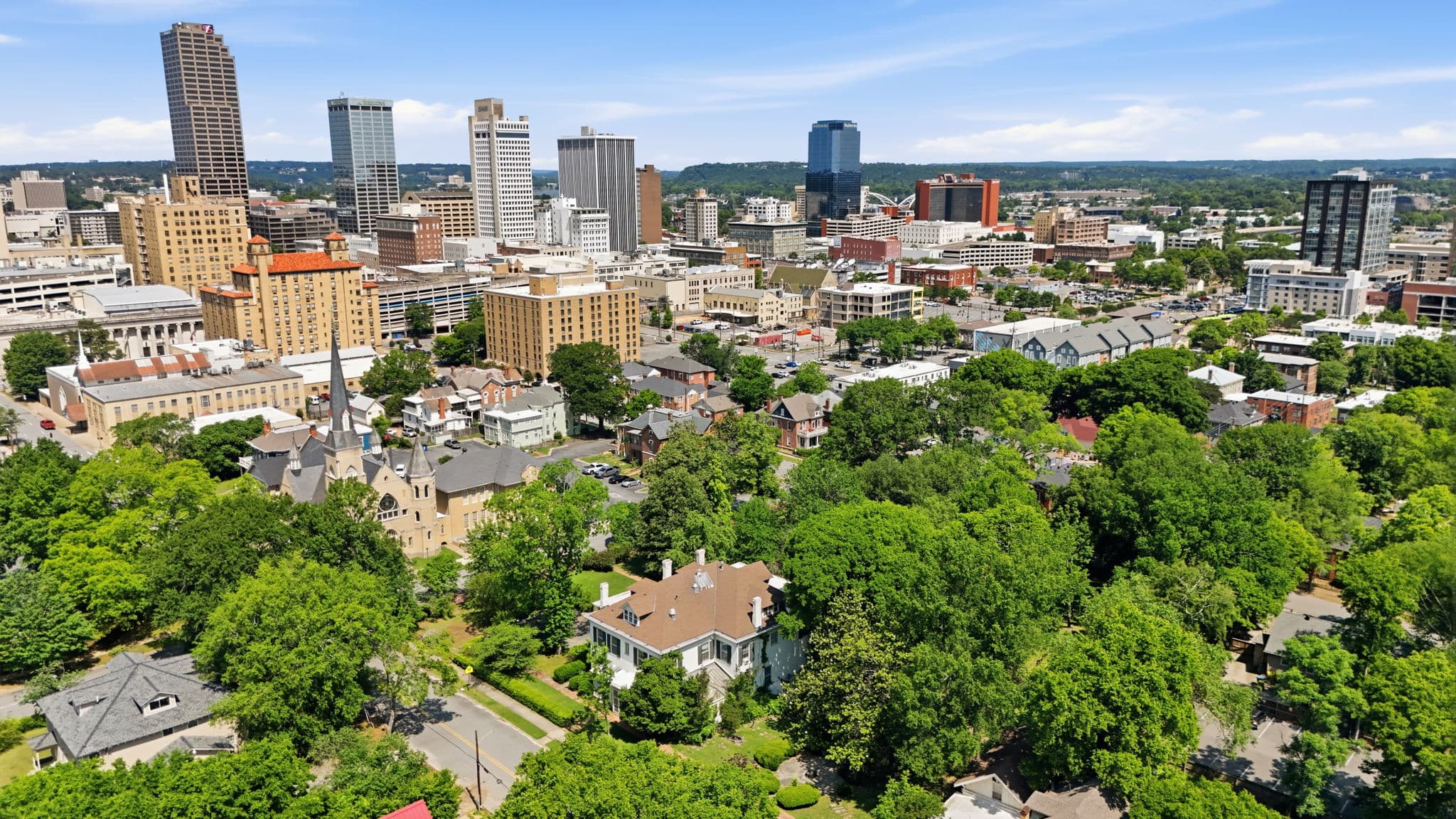 Aerial photo over a historic Little Rock neighborhood with the downtown skyline behind it, from a shoot at 411 7th Street