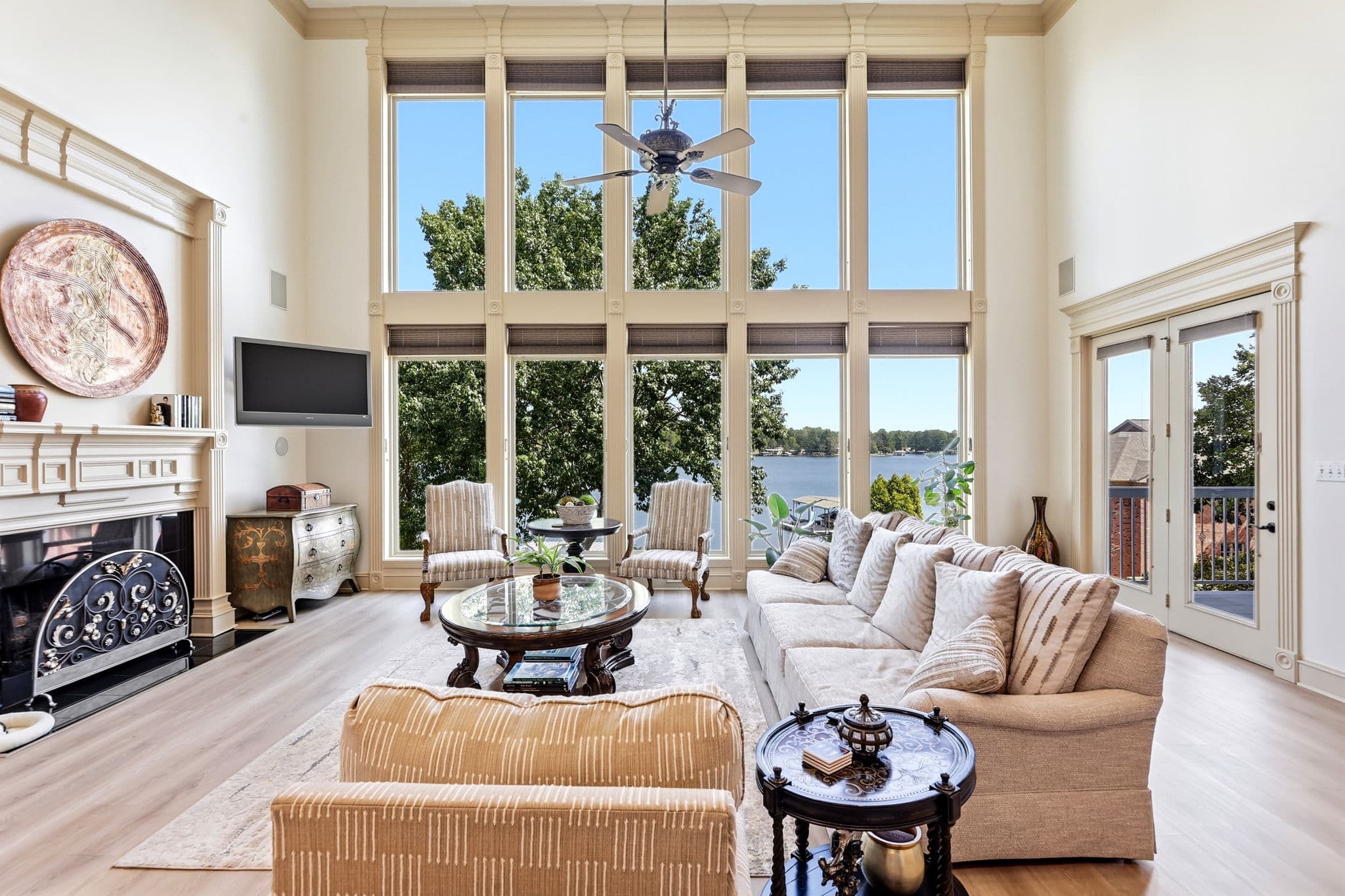 Two story great room with lake facing windows in a waterfront home listing in Hot Springs, Arkansas
