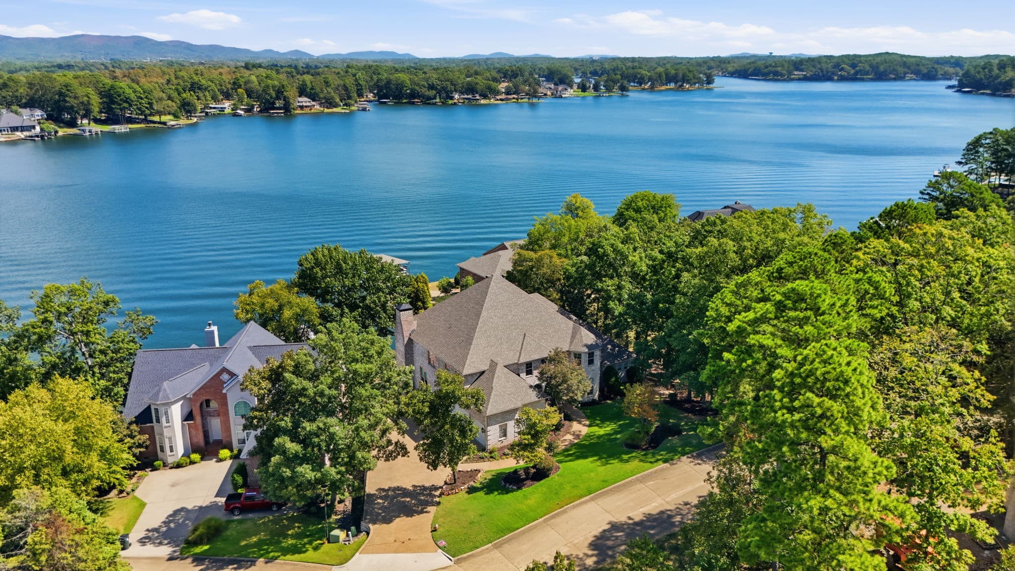 Aerial photo of a lakefront estate listing in Hot Springs, Arkansas, with the mountains behind it